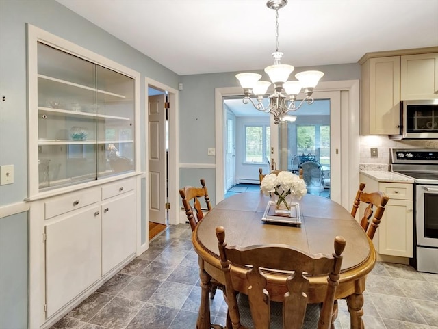 442 Purchase St, Easton, MA 02375 - dining room with a chandelier, stone finish flooring, baseboard heating, and baseboards