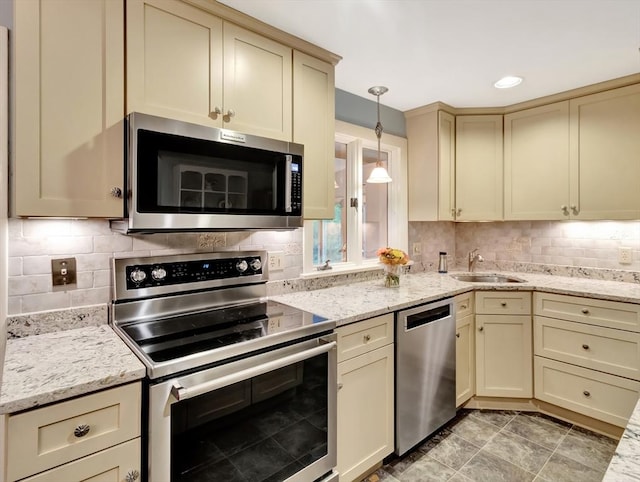 442 Purchase St, Easton, MA 02375 - kitchen with stainless steel appliances, a sink, cream cabinets, decorative backsplash, and recessed lighting
