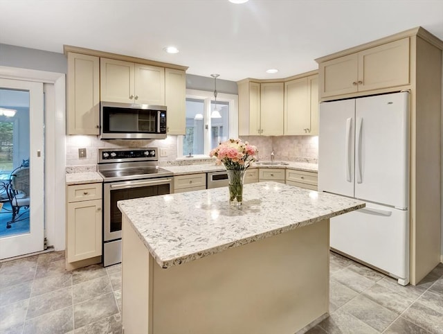 442 Purchase St, Easton, MA 02375 - kitchen with appliances with stainless steel finishes, cream cabinetry, decorative backsplash, light stone countertops, and recessed lighting