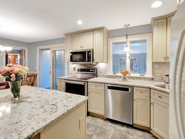 442 Purchase St, Easton, MA 02375 - kitchen with appliances with stainless steel finishes, decorative backsplash, decorative light fixtures, cream cabinetry, and recessed lighting