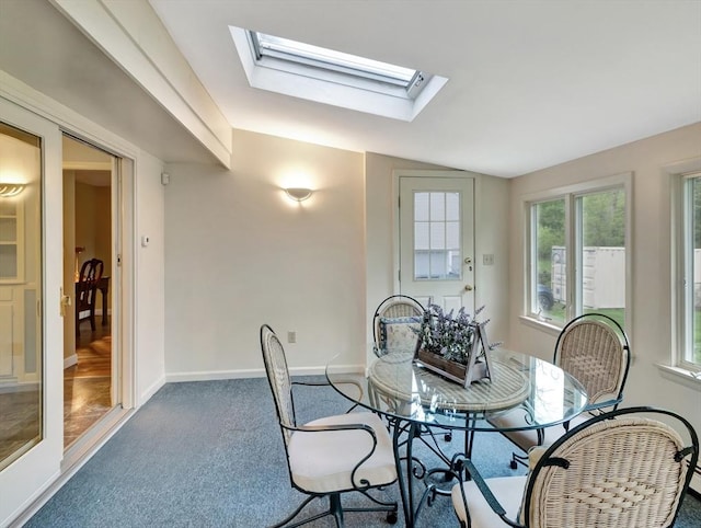 442 Purchase St, Easton, MA 02375 - carpeted dining space with baseboards, vaulted ceiling, and a skylight