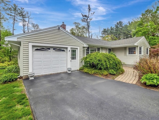 442 Purchase St, Easton, MA 02375 - single story home with a chimney, asphalt driveway, and an attached garage