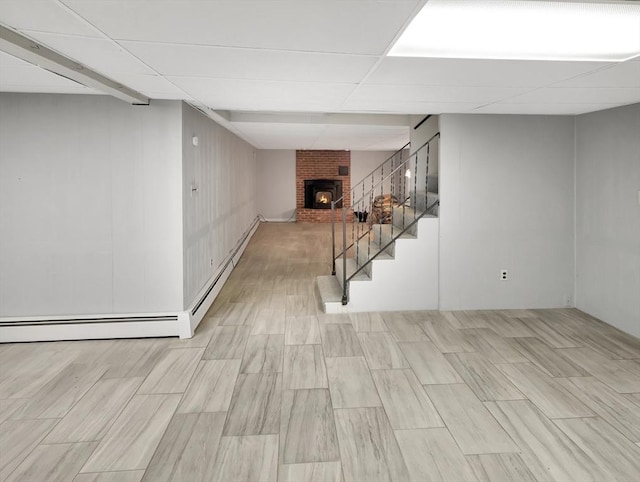 442 Purchase St, Easton, MA 02375 - below grade area featuring a paneled ceiling, stairs, a brick fireplace, and wood finished floors