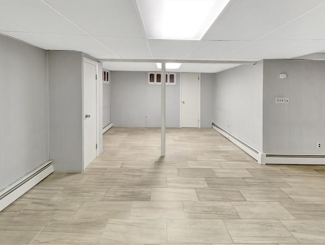 442 Purchase St, Easton, MA 02375 - finished basement with a baseboard heating unit and a paneled ceiling