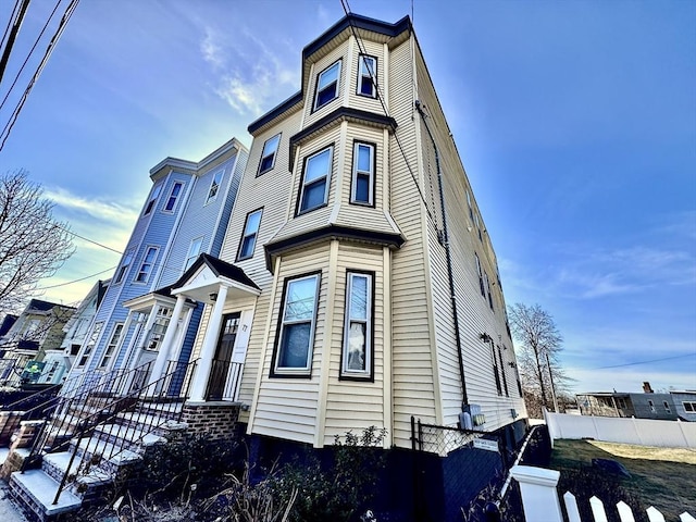 view of front of house featuring fence