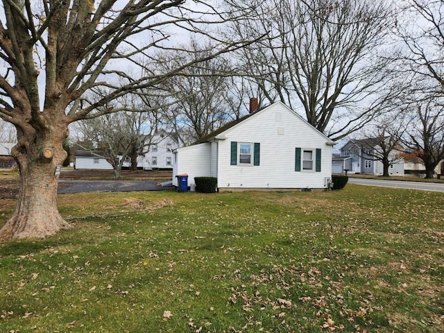 view of side of home with a lawn