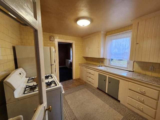 kitchen featuring white appliances and sink