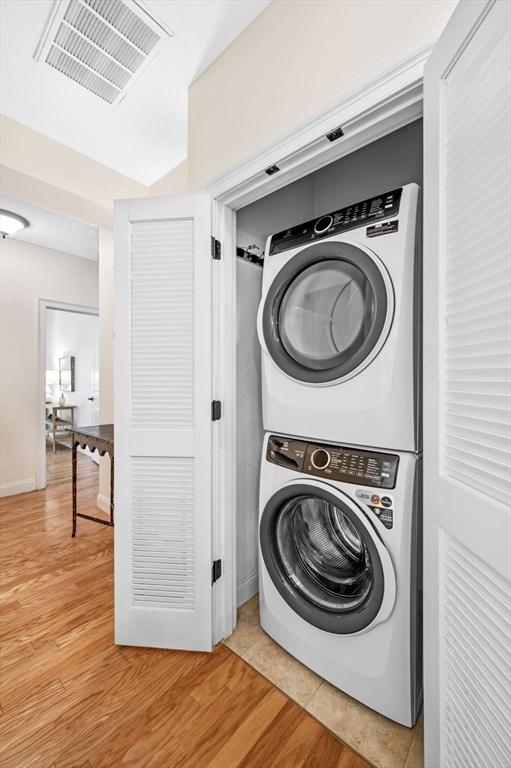 16 Green St Unit 11, Ipswich, MA 01938 - laundry room featuring stacked washer / dryer and light wood-style floors
