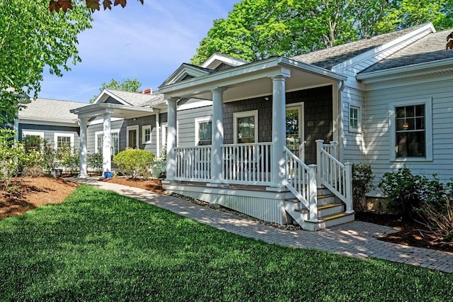 16 Green St Unit 11, Ipswich, MA 01938 - view of front of house with a porch, a front yard, and a shingled roof