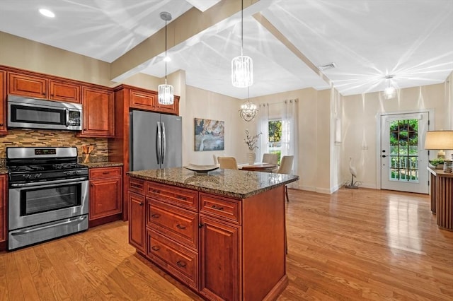 16 Green St Unit 11, Ipswich, MA 01938 - kitchen with stainless steel appliances, a chandelier, light wood-type flooring, tasteful backsplash, and healthy amount of natural light