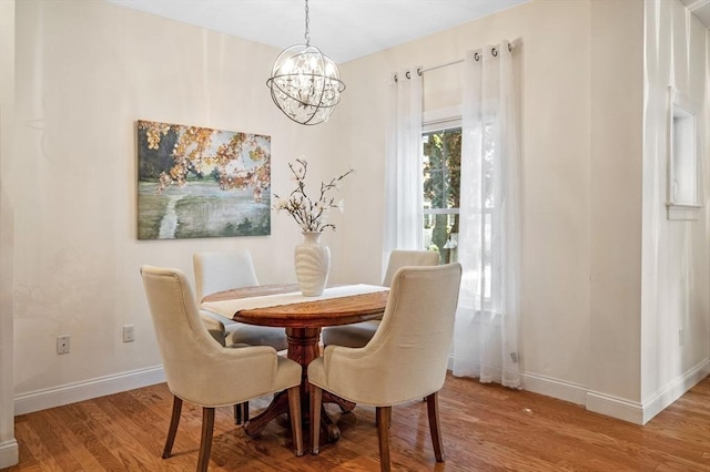 16 Green St Unit 11, Ipswich, MA 01938 - dining space featuring a chandelier, wood finished floors, and baseboards