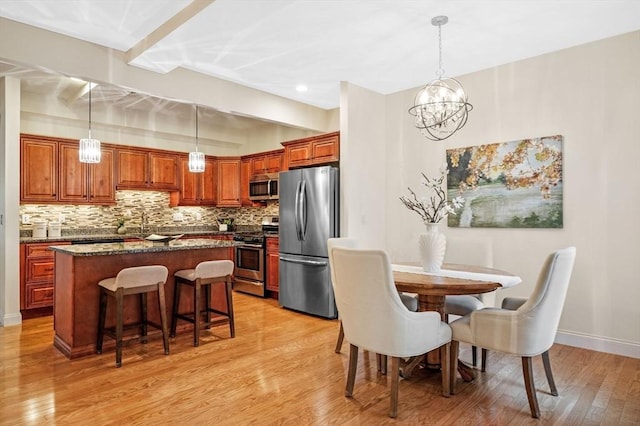 16 Green St Unit 11, Ipswich, MA 01938 - dining space featuring light wood-type flooring, a chandelier, baseboards, and recessed lighting