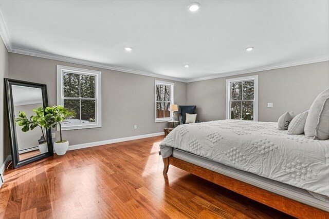 bedroom with hardwood / wood-style floors and ornamental molding