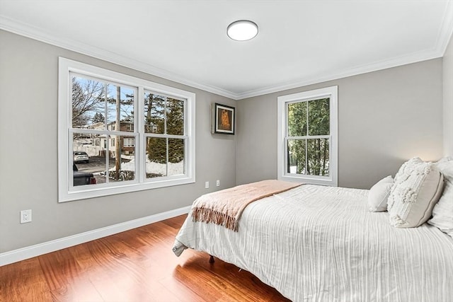 bedroom with hardwood / wood-style flooring and ornamental molding