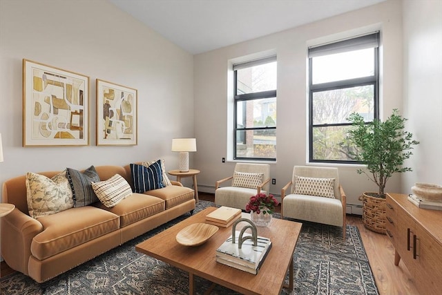 living room with baseboard heating and dark wood-type flooring