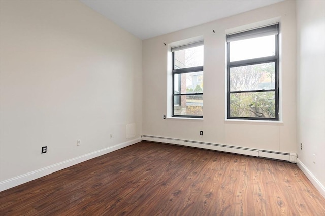 unfurnished room featuring a baseboard radiator and dark hardwood / wood-style floors