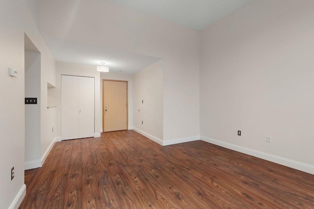 empty room with dark hardwood / wood-style flooring