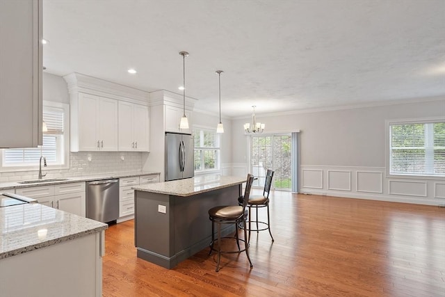 295 Sewall St Unit 295, Boylston, MA 01505 - kitchen with stainless steel appliances, a sink, a chandelier, healthy amount of natural light, and ornamental molding