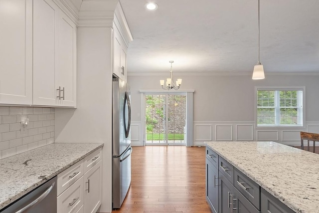 295 Sewall St Unit 295, Boylston, MA 01505 - kitchen with stainless steel appliances, a chandelier, white cabinetry, pendant lighting, and crown molding