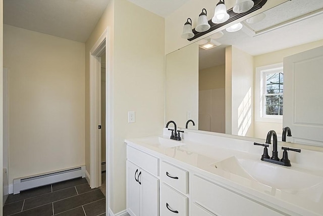 bathroom featuring vanity, a baseboard heating unit, and tile patterned floors