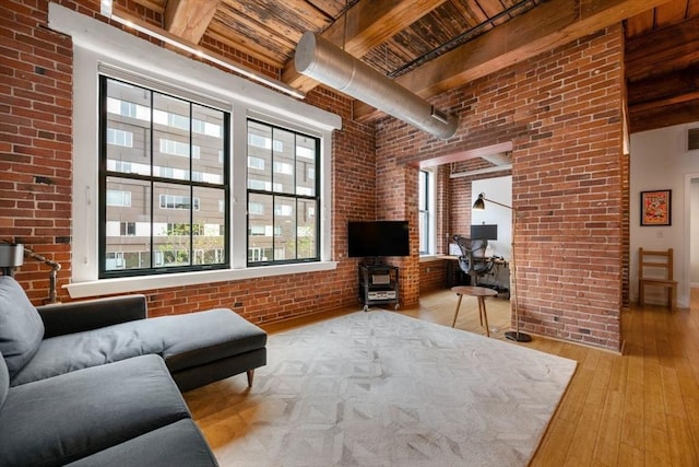 living room with brick wall, beam ceiling, wood ceiling, and hardwood / wood-style flooring