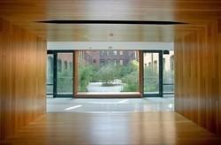 doorway to outside with wood walls