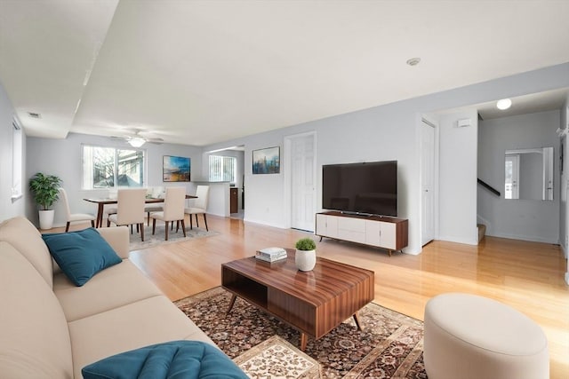360 Littleton Unit D1, Chelmsford, MA 01824 - living area with light wood-style floors, ceiling fan, baseboards, and stairs