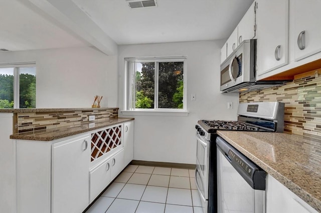 360 Littleton Unit D1, Chelmsford, MA 01824 - kitchen featuring stainless steel appliances, decorative backsplash, white cabinets, light tile patterned floors, and baseboards