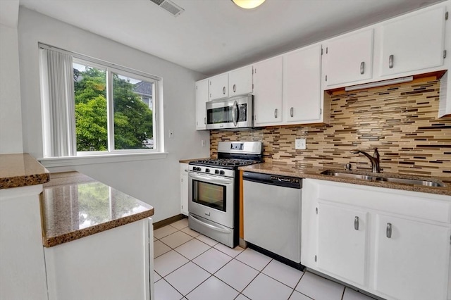 360 Littleton Unit D1, Chelmsford, MA 01824 - kitchen with appliances with stainless steel finishes, a sink, decorative backsplash, white cabinets, and stone counters