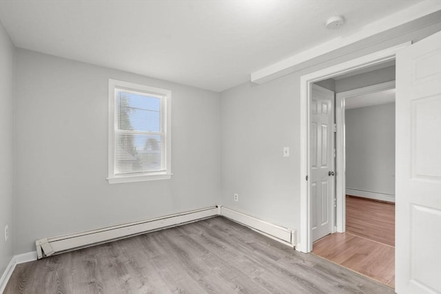 78-82 3rd St, Lowell, MA 01850 - spare room featuring wood finished floors, a baseboard radiator, and a smoke detector