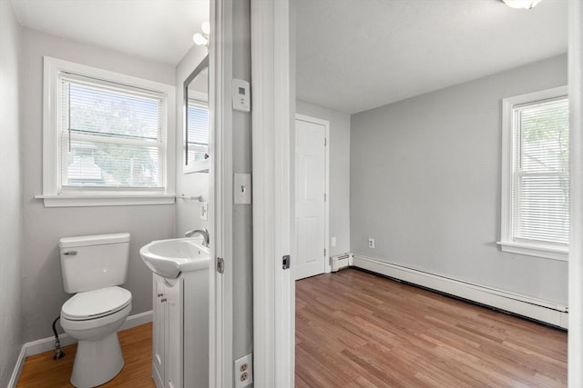 78-82 3rd St, Lowell, MA 01850 - half bath featuring baseboard heating, vanity, and wood finished floors