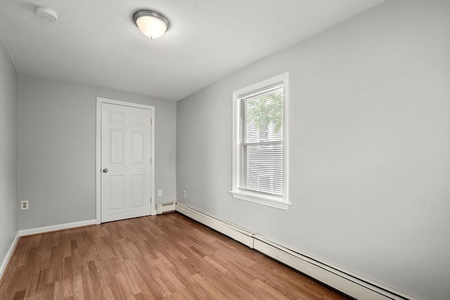 78-82 3rd St, Lowell, MA 01850 - unfurnished bedroom featuring a baseboard heating unit and wood finished floors