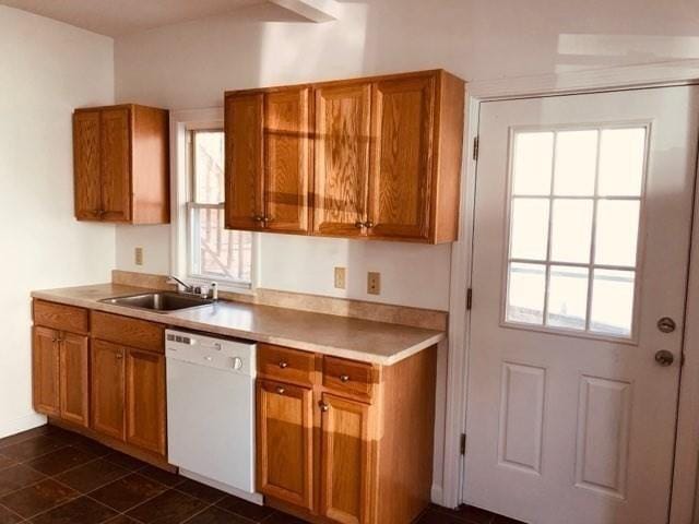 78-82 3rd St, Lowell, MA 01850 - kitchen with dishwasher, brown cabinetry, light countertops, and dark tile patterned floors