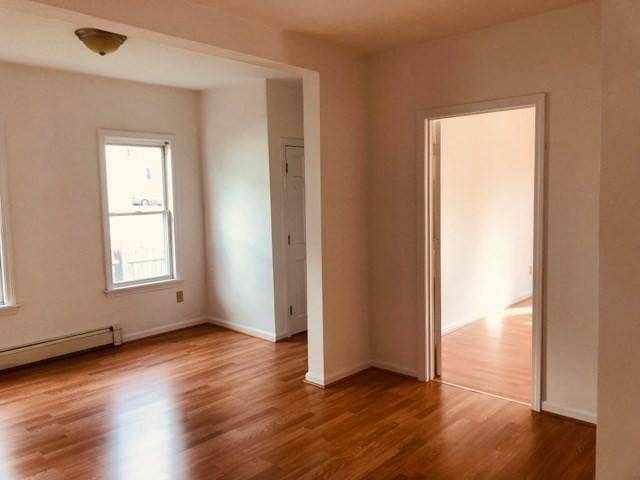 78-82 3rd St, Lowell, MA 01850 - spare room featuring a baseboard heating unit and wood finished floors