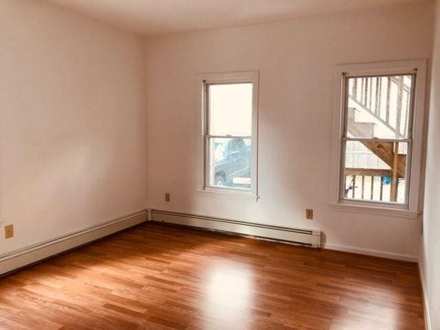78-82 3rd St, Lowell, MA 01850 - unfurnished room with wood finished floors and a baseboard radiator
