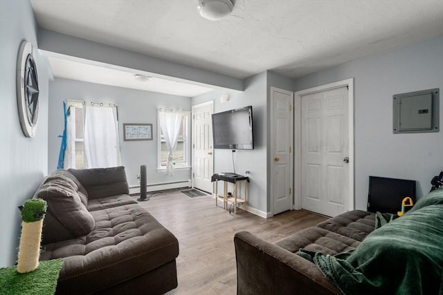 78-82 3rd St, Lowell, MA 01850 - living room with electric panel, wood finished floors, and a baseboard radiator