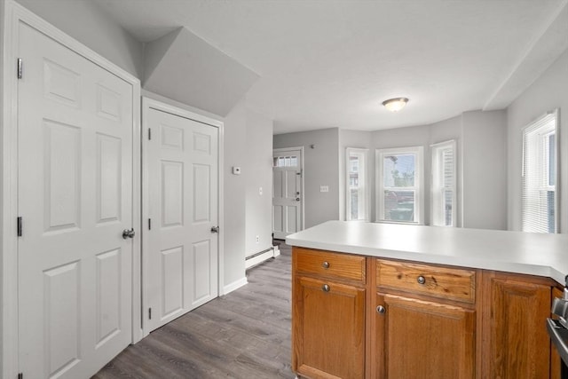 78-82 3rd St, Lowell, MA 01850 - kitchen with a baseboard heating unit, healthy amount of natural light, and brown cabinets