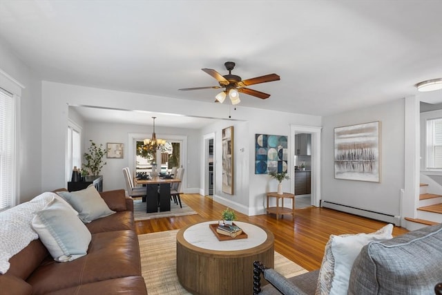 21 Ames, Lynn, MA 01905 - living room featuring a baseboard heating unit, wood finished floors, a chandelier, and plenty of natural light