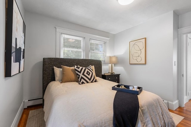 21 Ames, Lynn, MA 01905 - bedroom featuring a baseboard heating unit and wood finished floors