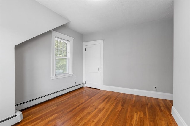 21 Ames, Lynn, MA 01905 - additional living space with a baseboard radiator and wood finished floors