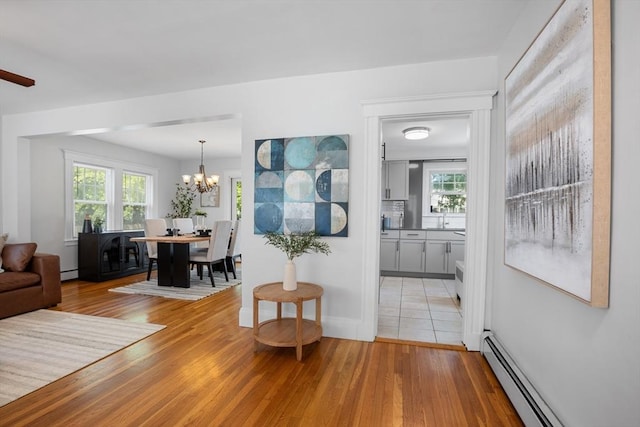 21 Ames, Lynn, MA 01905 - living room with a baseboard radiator, light wood-style floors, a chandelier, and a baseboard heating unit
