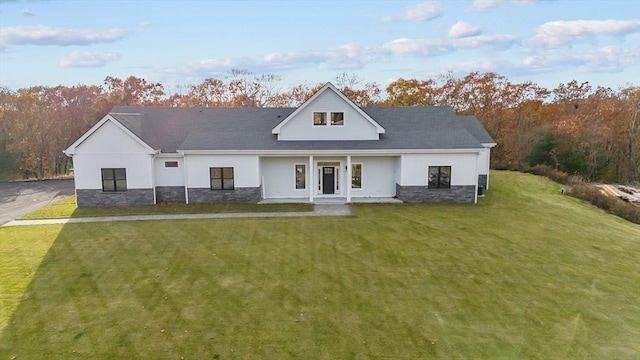 modern farmhouse style home featuring a front yard