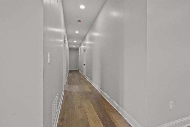 corridor with hardwood / wood-style floors