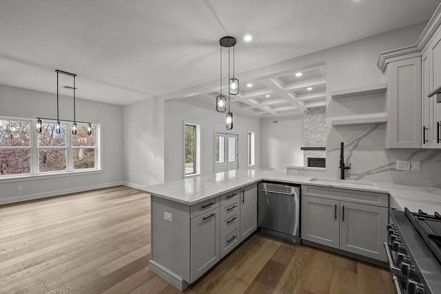 kitchen featuring gray cabinetry, sink, a fireplace, kitchen peninsula, and stainless steel appliances