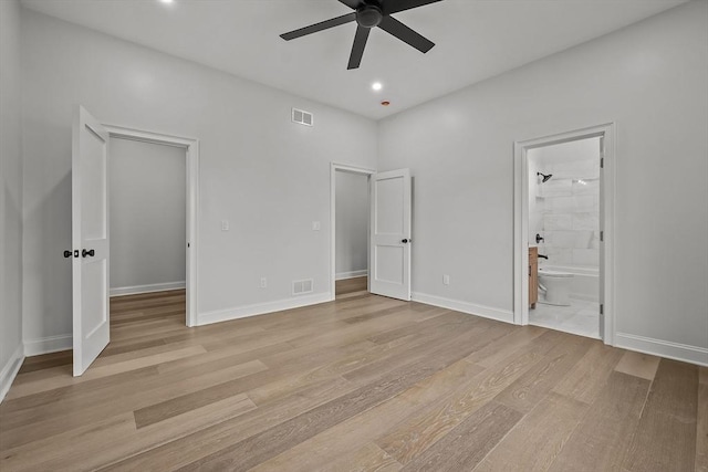 unfurnished bedroom with ensuite bathroom, ceiling fan, and light hardwood / wood-style flooring