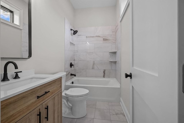 full bathroom with toilet, vanity, and tiled shower / bath