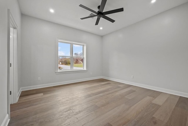 spare room with light hardwood / wood-style floors and ceiling fan