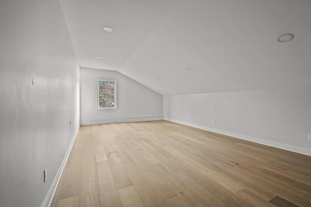 bonus room with light hardwood / wood-style flooring and vaulted ceiling