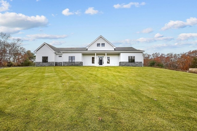 rear view of property with a lawn