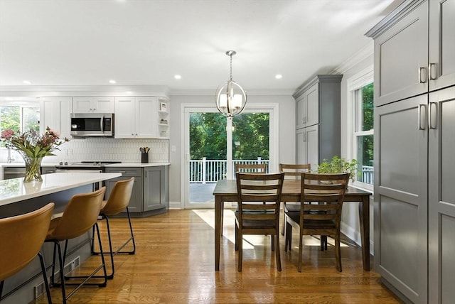 6 Flagg Dr, Framingham, MA 01702 - dining room featuring healthy amount of natural light, crown molding, light wood-style floors, and recessed lighting